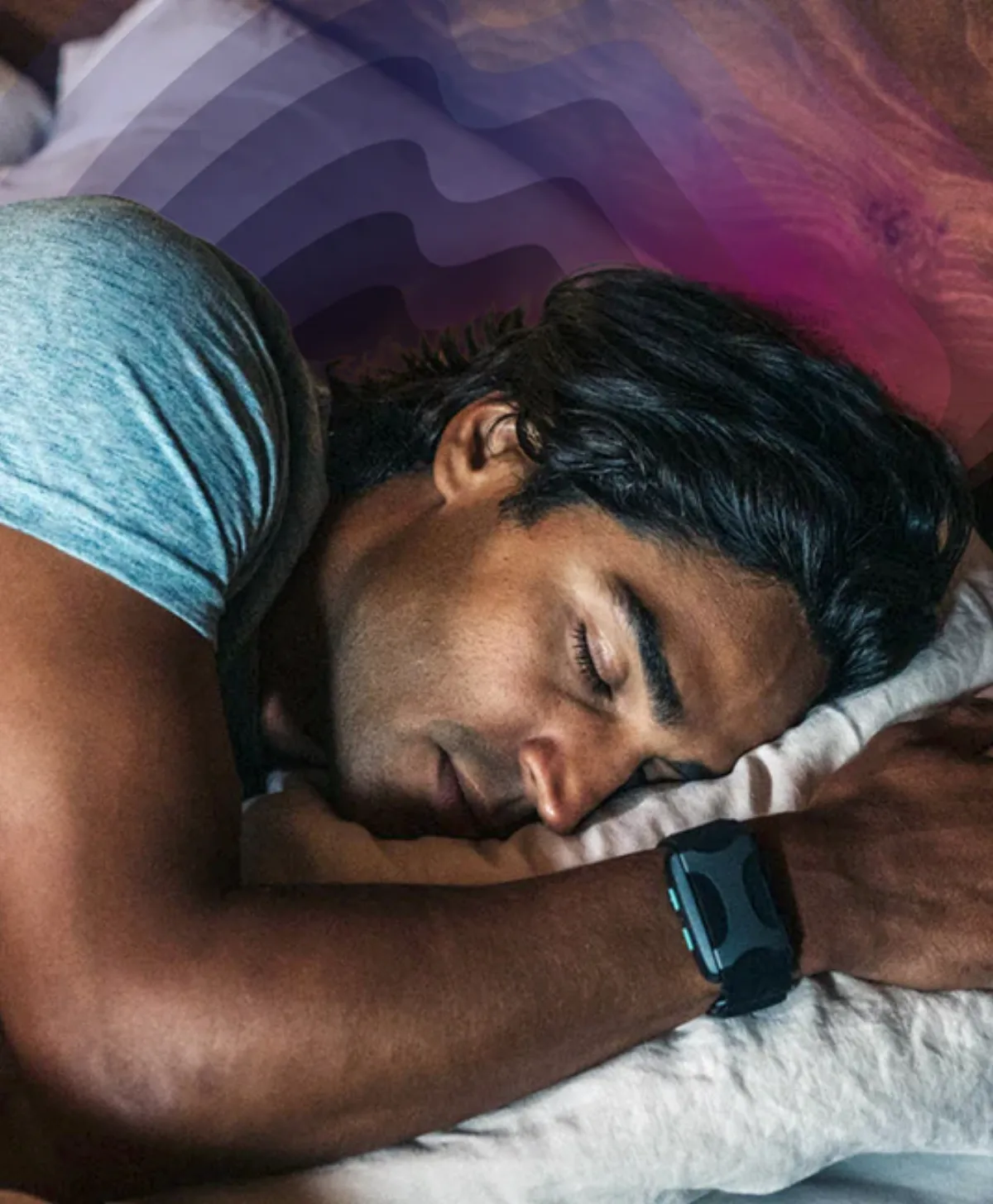 A man asleep on a pillow wearing the Apollo device