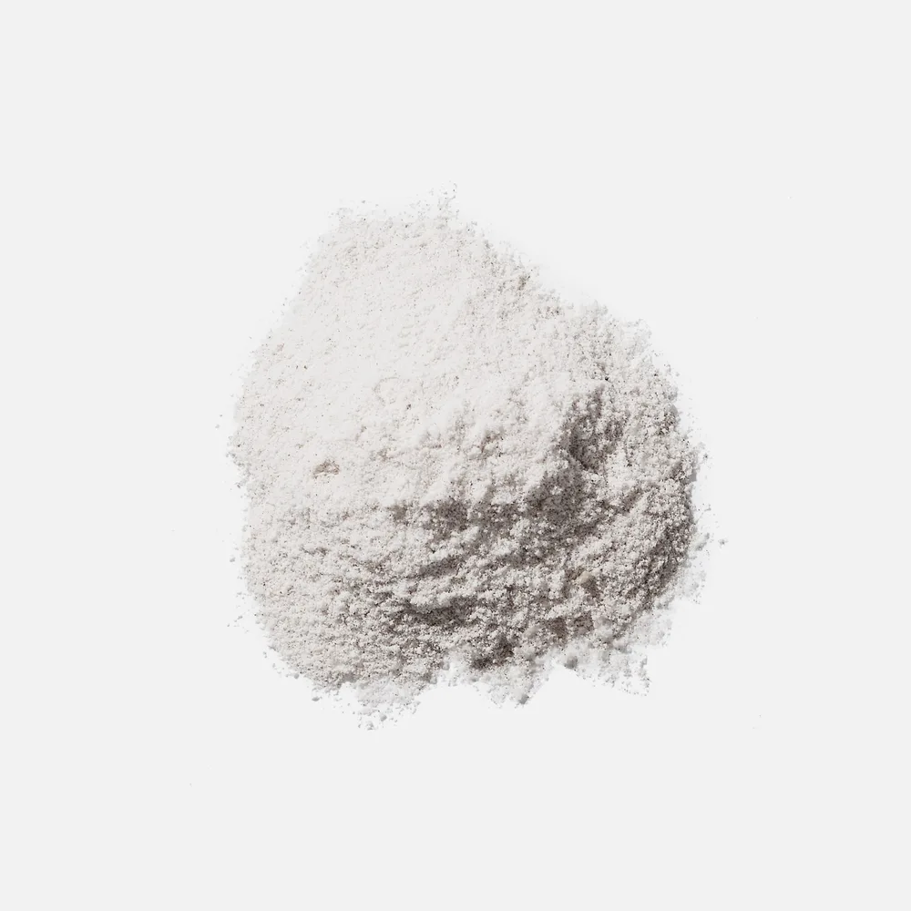 Loose ARMRA colostrum powder, pale and slightly clumped