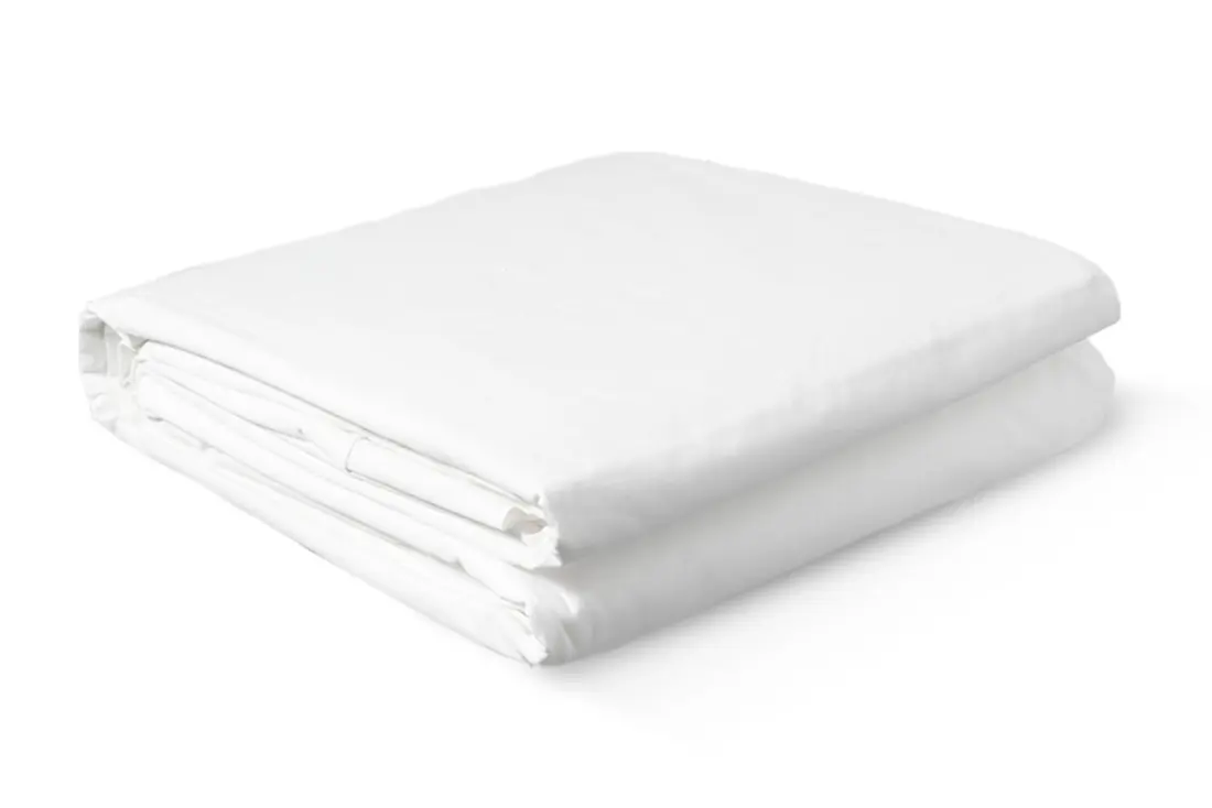 The BedJet Cloud Sheet folded, looking like an ordinary white cotton top sheet.