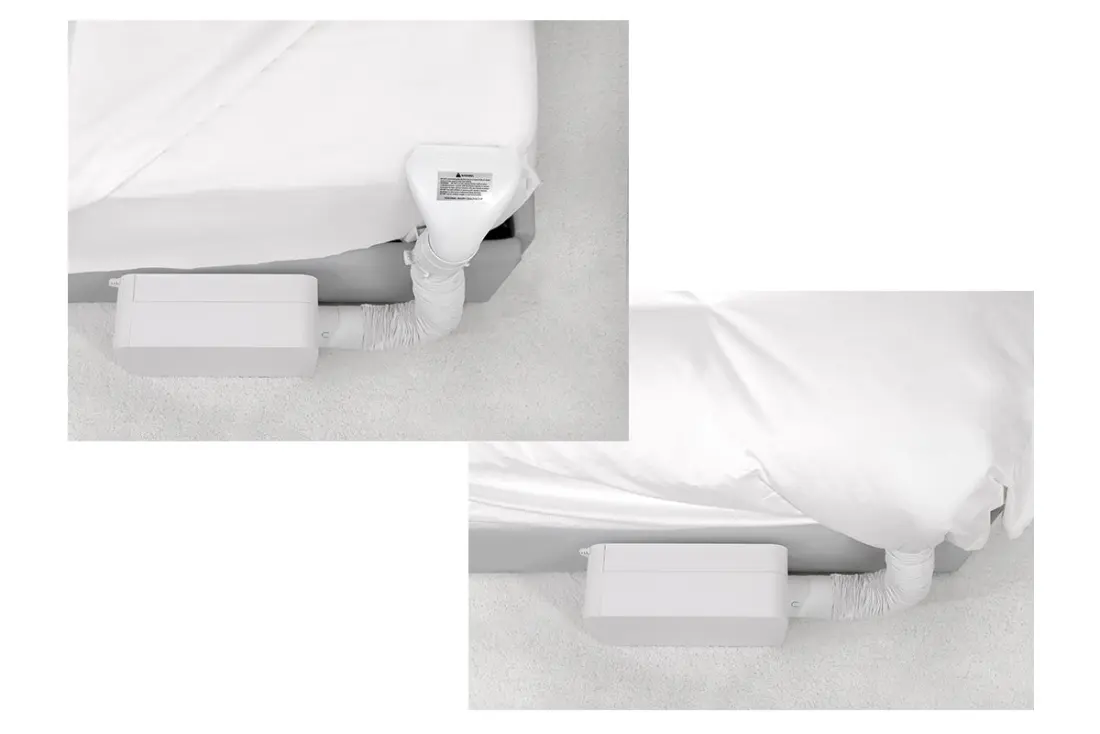 Close-up of the BedJet nozzle and mounting hardware clipped to the bedding.