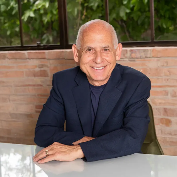 Dr. Daniel Amen seated at a table