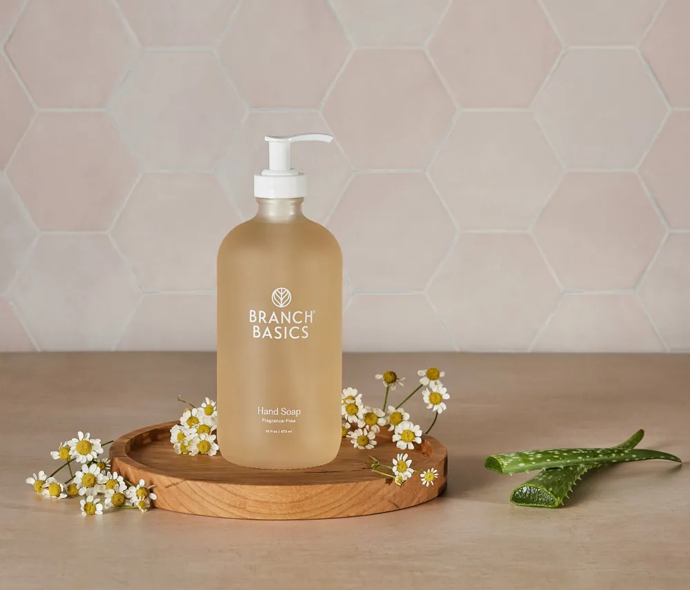 Branch Basics gel hand soap bottle beside fresh chamomile flowers