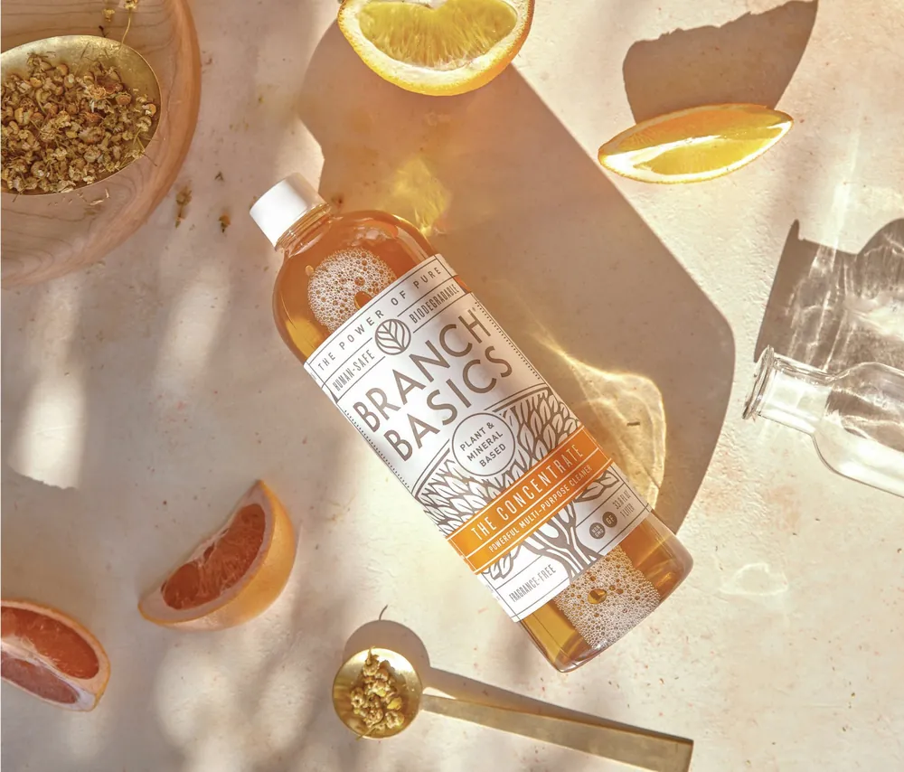Amber cleaning concentrate bottle photographed from above with citrus and chamomile