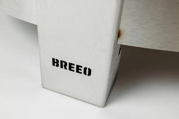 Close view of a stainless steel leg of a Breeo fire pit stamped with the Breeo logo
