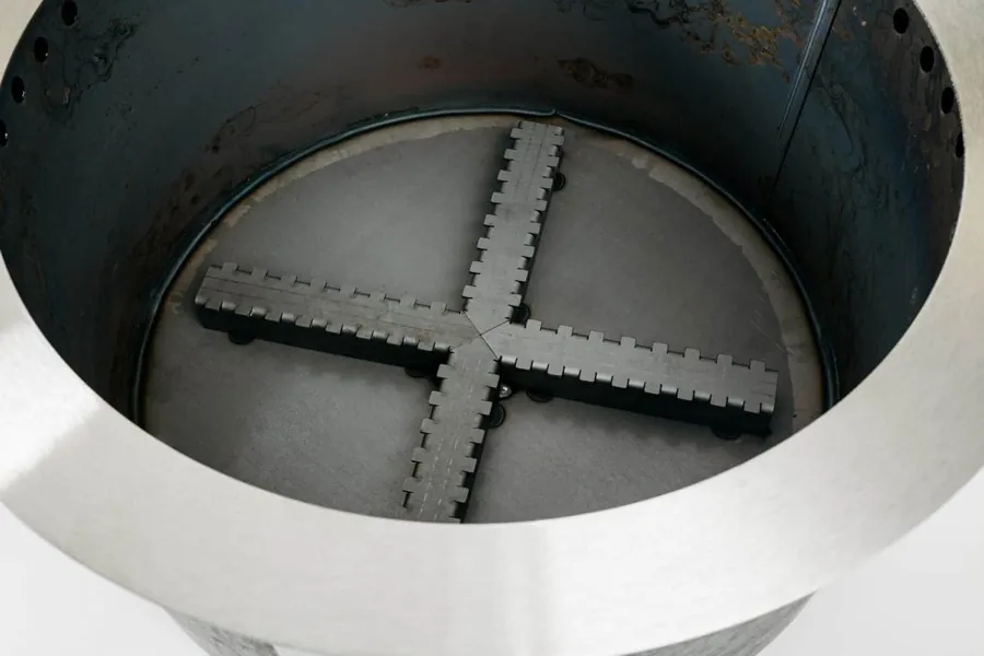 Inside of a Breeo X24 showing the raised cross shaped air vent sitting above the floor of the pit