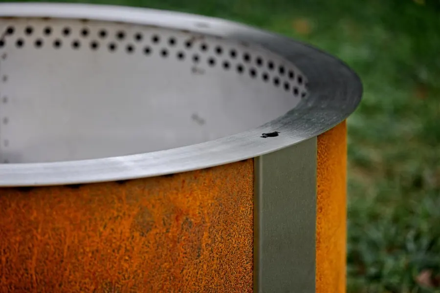 A large Breeo X42 corten steel fire pit standing outdoors with a weathered patina