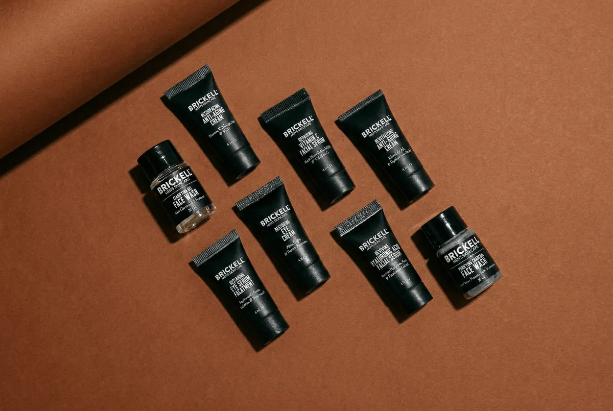 Eight small Brickell sample tubes and jars arranged on a terracotta background