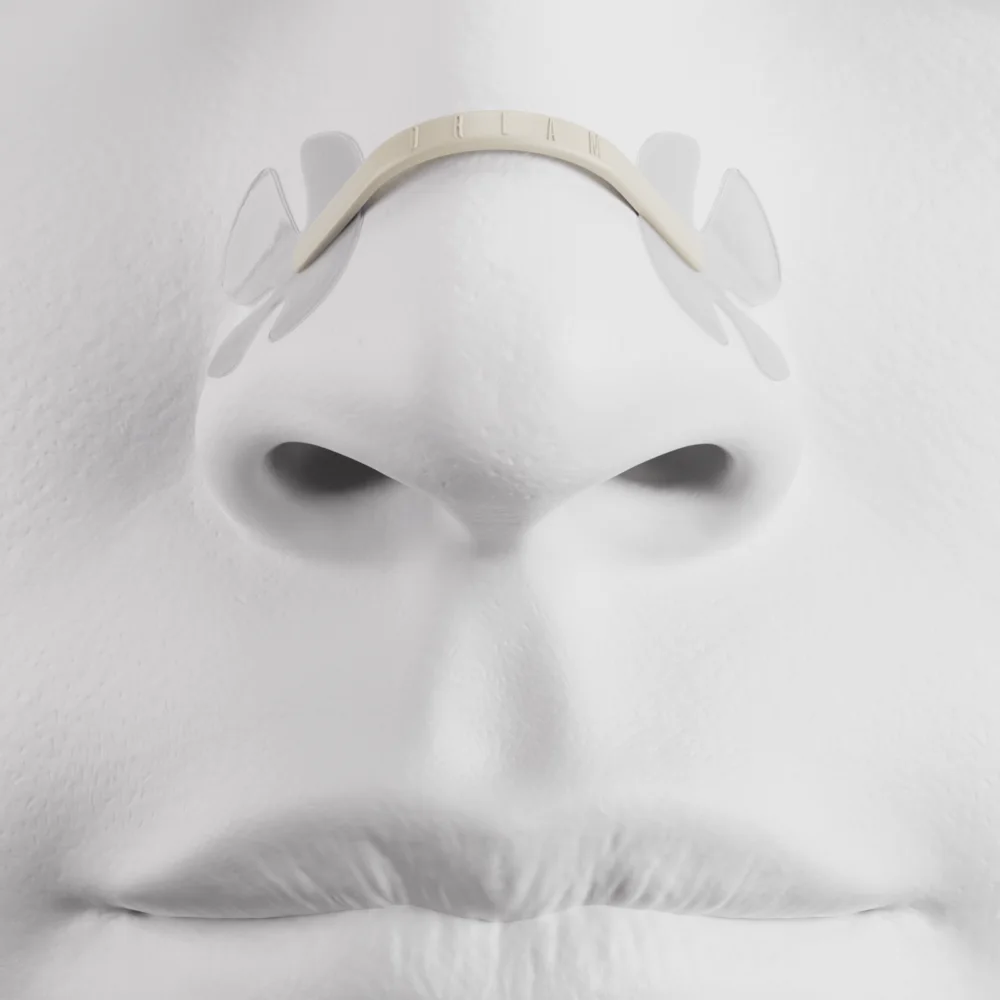 Front view of a plain white anatomical model wearing the nasal strip, showing the two translucent adhesive wings spread across each nostril wall