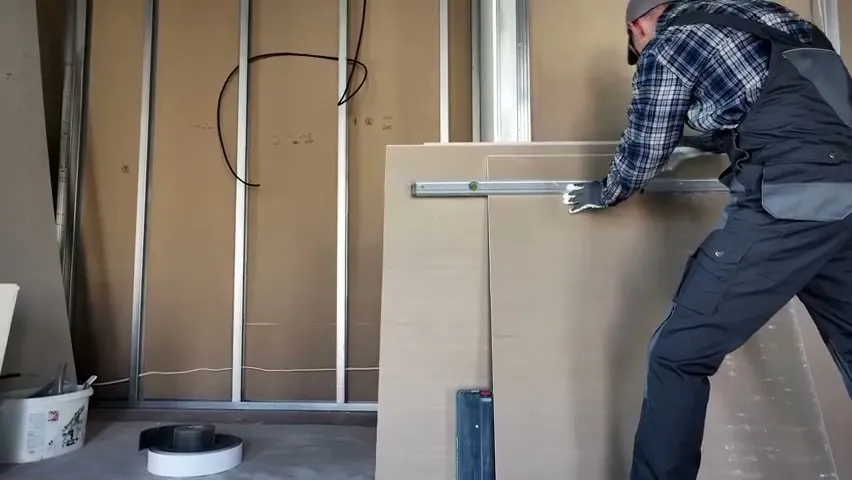 A tradesman fitting panels on a job site, from the Duke Cannon product film