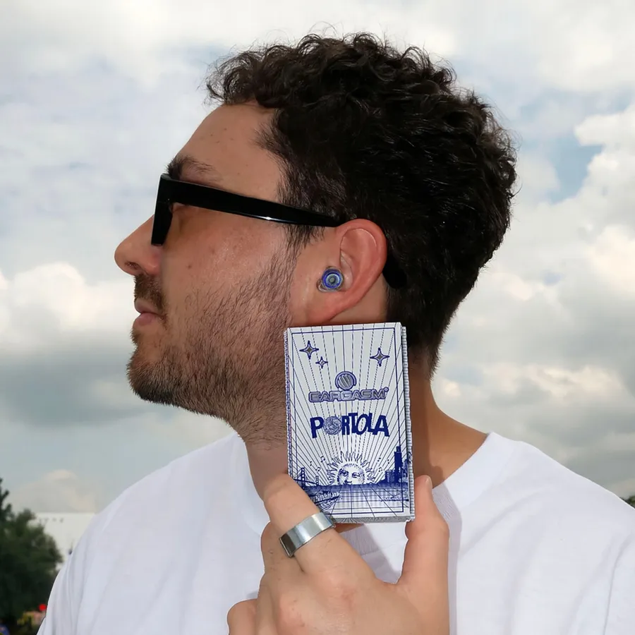 A festival goer holding a limited edition Eargasm box outdoors