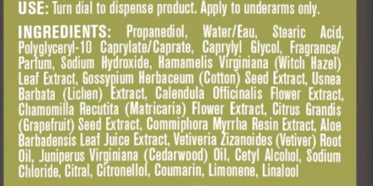 Close-up of the printed ingredient list on the back of an Every Man Jack Coastal Forest aluminum free deodorant, listing propanediol, water, stearic acid, witch hazel, cotton seed extract, lichen extract, calendula, chamomile, grapefruit seed, myrrh, aloe, vetiver and cedarwood
