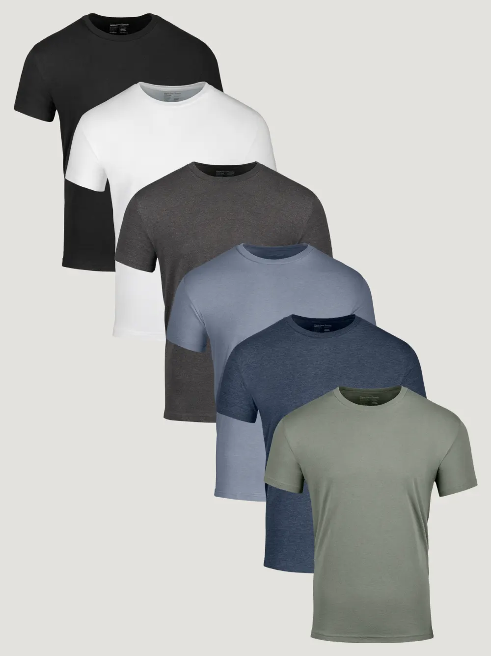 Six Fresh Clean Threads crew neck tees laid out in black, white, charcoal, blue, navy and green.