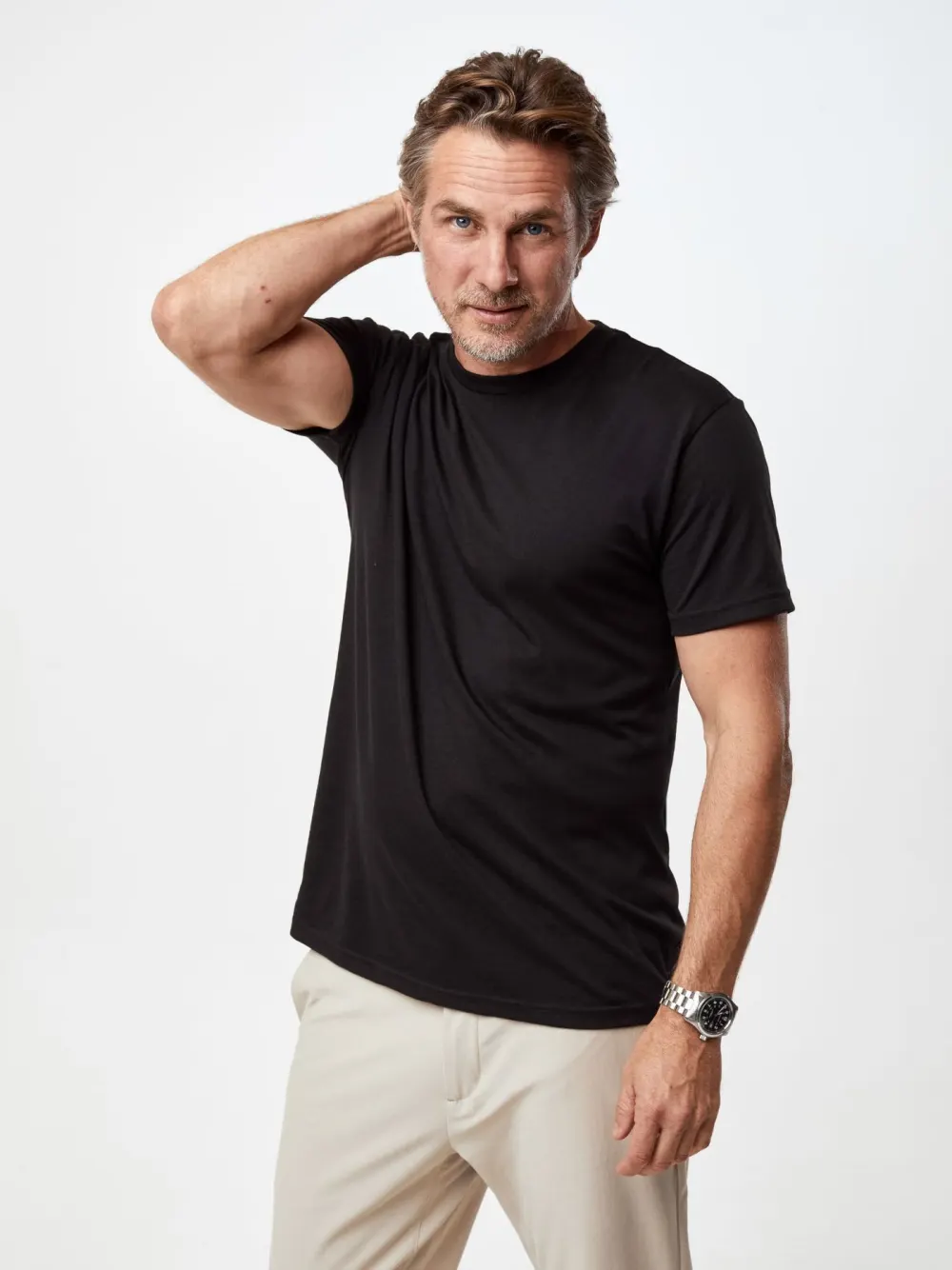 Close view of the sleeve and armhole on a black Fresh Clean Threads crew neck tee.