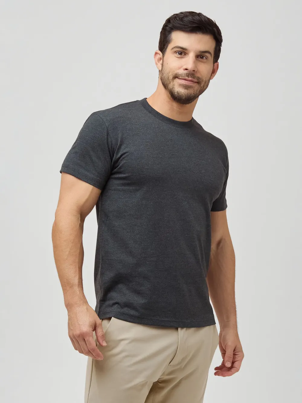 Side view of a man wearing a charcoal Fresh Clean Threads crew neck tee.