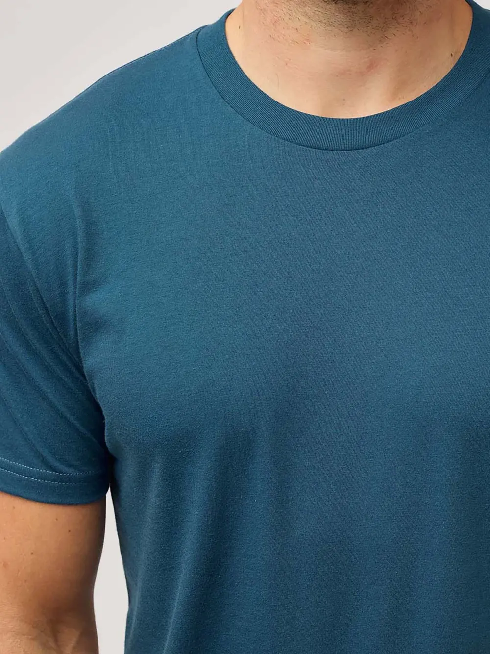 Close view of the collar and shoulder of a blue Fresh Clean Threads crew neck tee.
