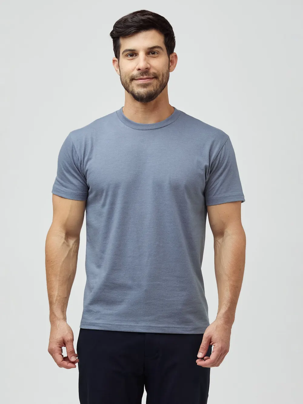 A man wearing a blue Fresh Clean Threads crew neck tee, front view.