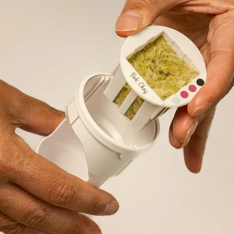 Hand holding a Gardyn yCube seed pod