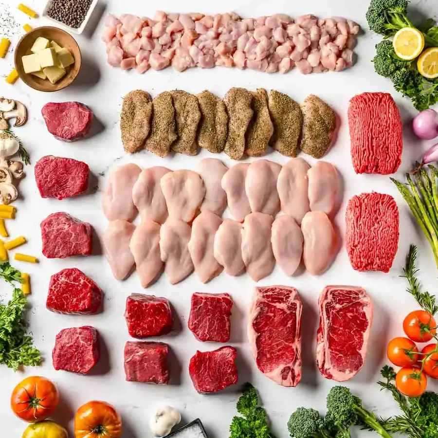 A full Good Ranchers box laid out: steaks, ground beef, chicken breasts, burgers and seasonings