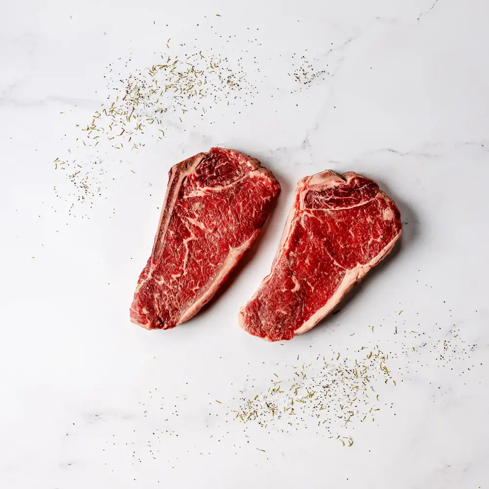 Two bone-in New York strip steaks
