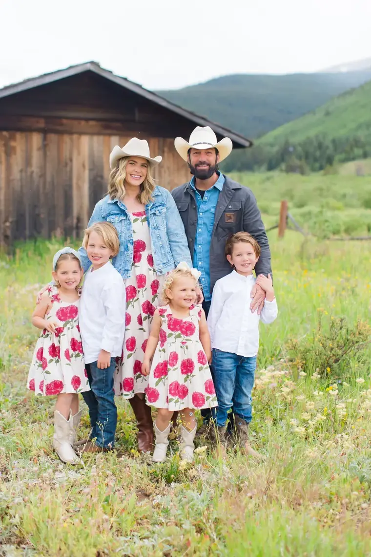 Ben and Corley Spell with their four children, standing in front of a barn