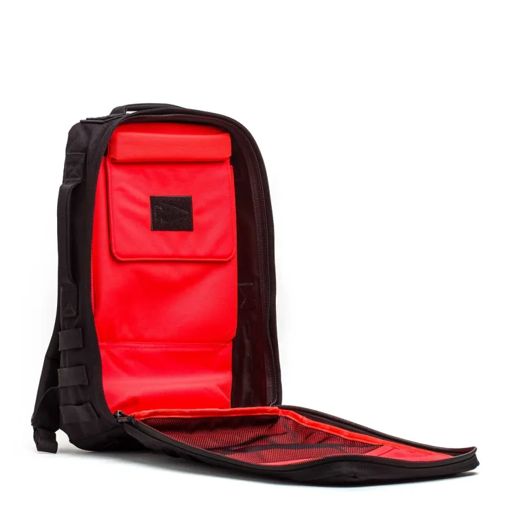 A Rucker 5.0 opened flat, showing the internal elevated ruck plate pockets against the back panel