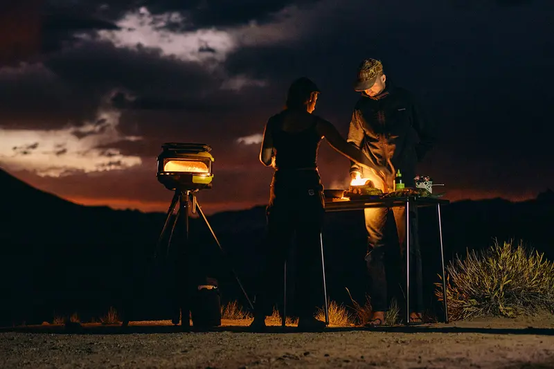 A Gozney Tread oven set up on a stand outdoors at dusk.