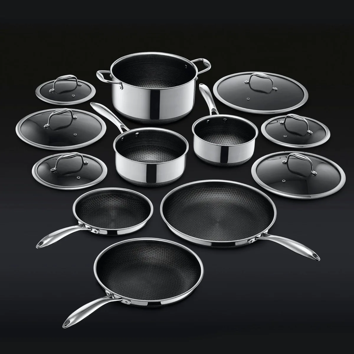 The full HexClad Hybrid cookware collection of pots and pans arranged together on a black background