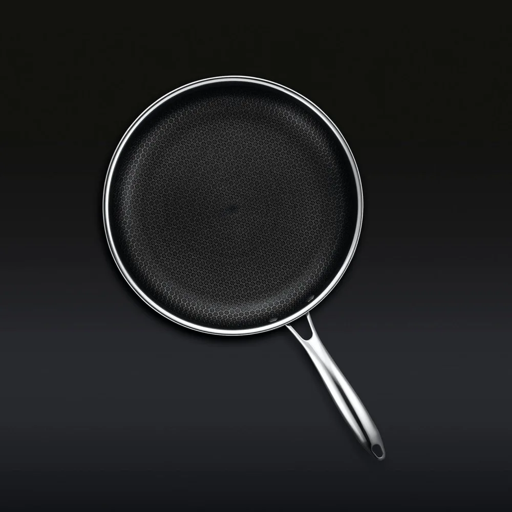 Overhead view of a HexClad Hybrid fry pan showing the full hexagon grid covering the cooking surface