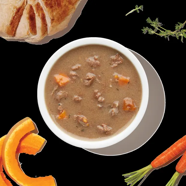 Bowl of beef bone broth stew topper with carrots