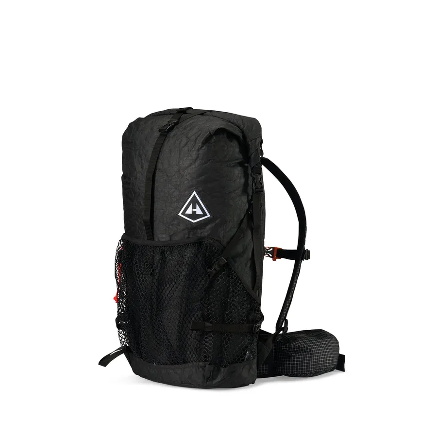 Black Windrider backpack with three external mesh pockets, shown from the side.