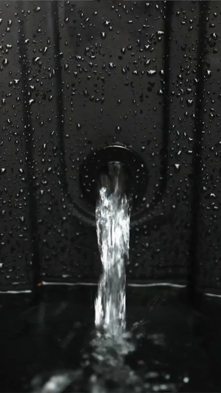 Water from a hose filling an Ice Barrel