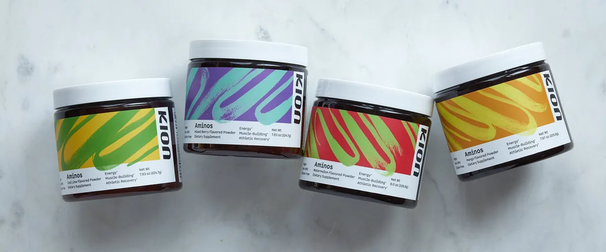 The four Kion Aminos powder flavors lined up on a marble surface