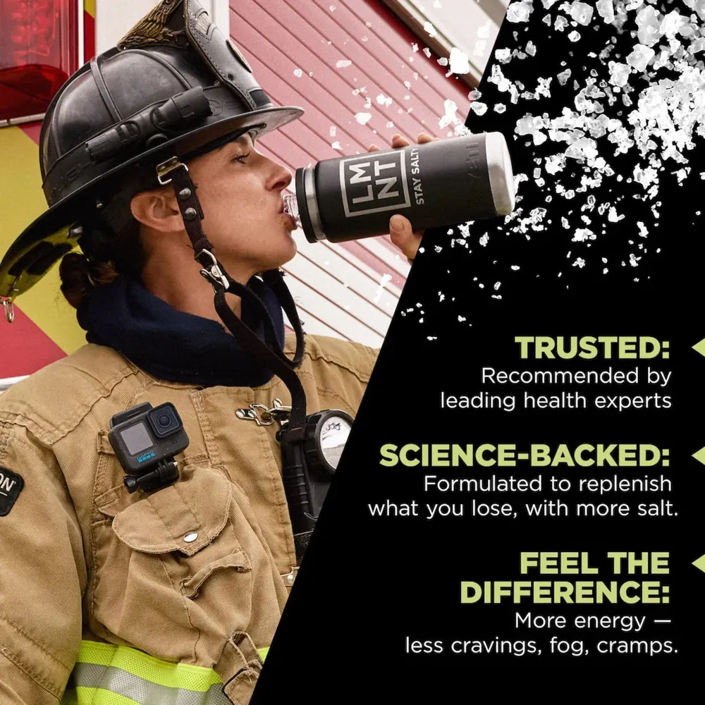 A firefighter in full turnout gear drinking from a bottle