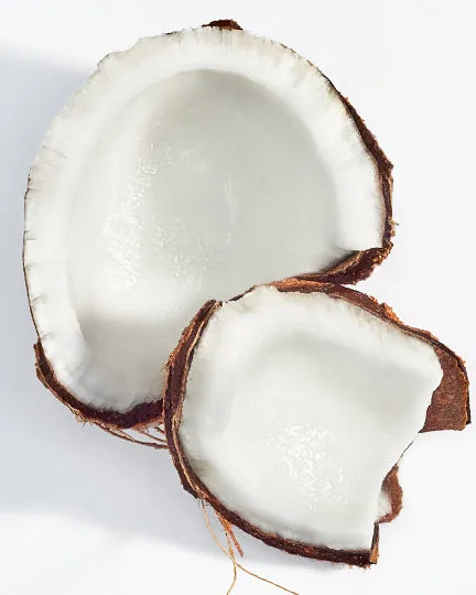 A coconut cracked open into two halves.