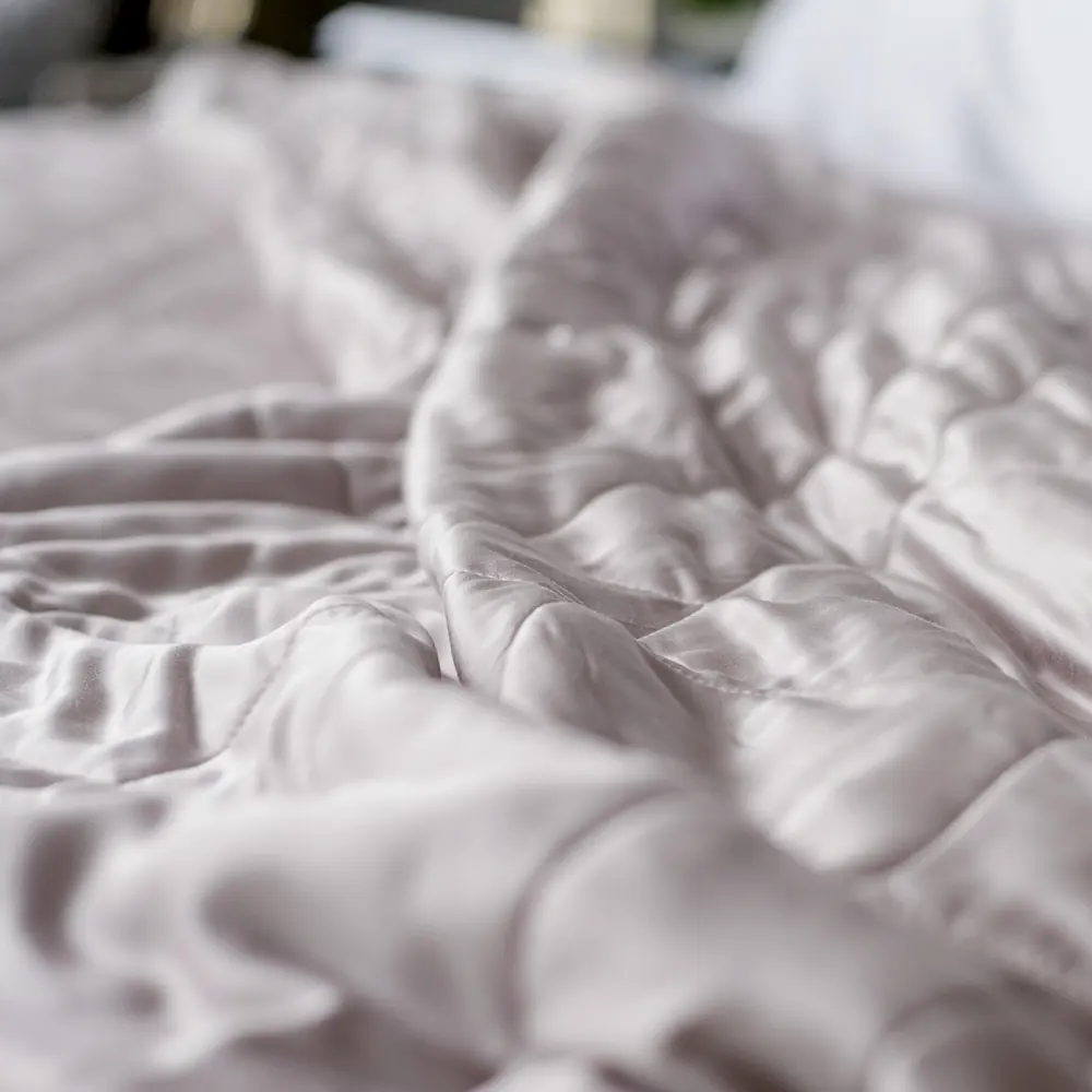 Close view of the diamond quilting on the Luxome Lightweight Blanket lying on a bed