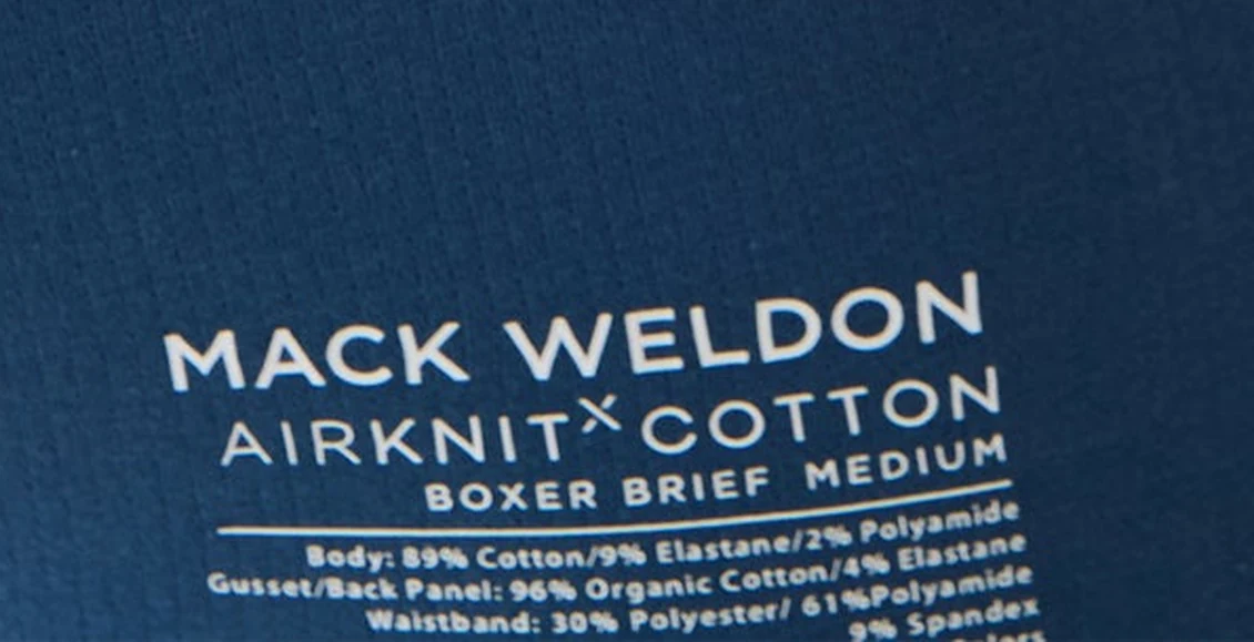 Zoom on the printed waistband label of the AIRKNITx Cotton boxer brief listing three separate fabric compositions