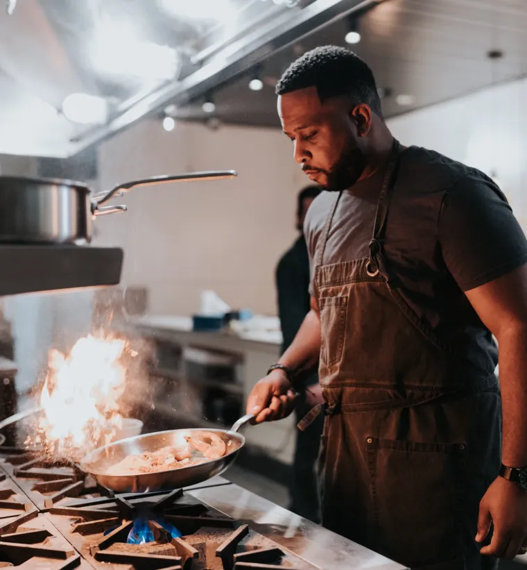 Chef Matt Horn cooking over a flaming pan