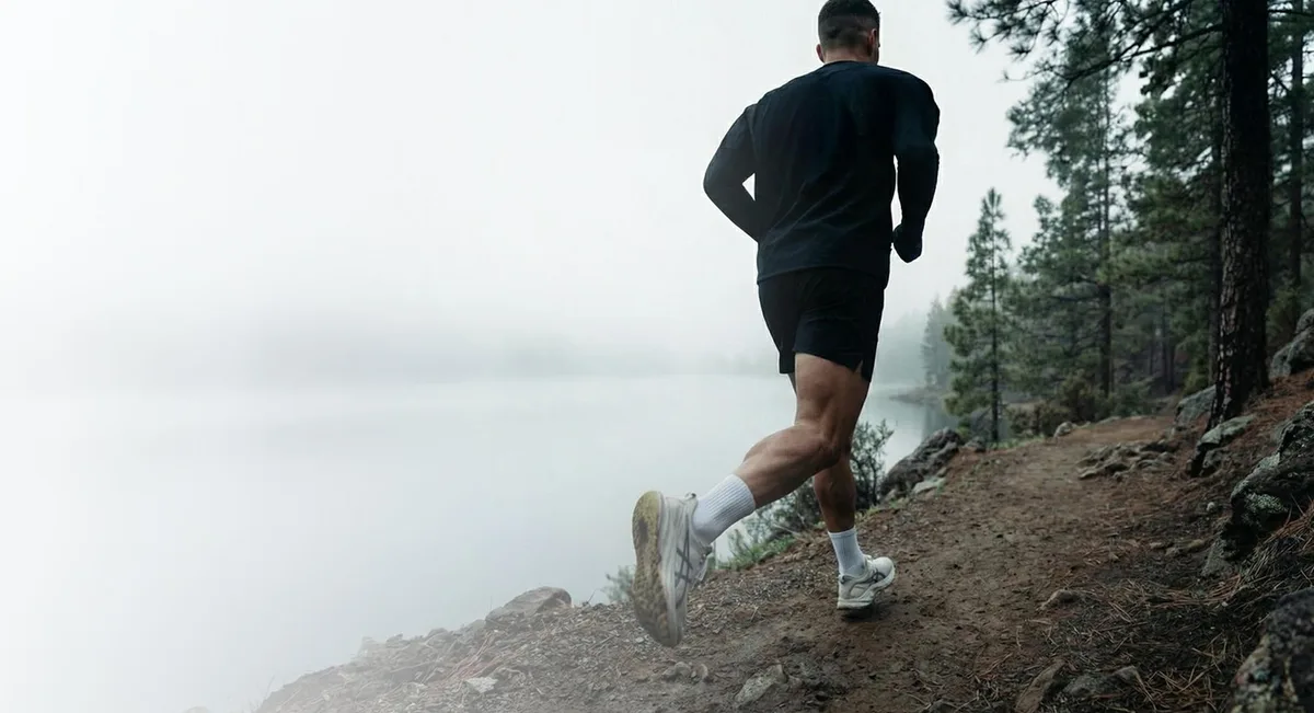 Man running on a coastal trail in the early morning