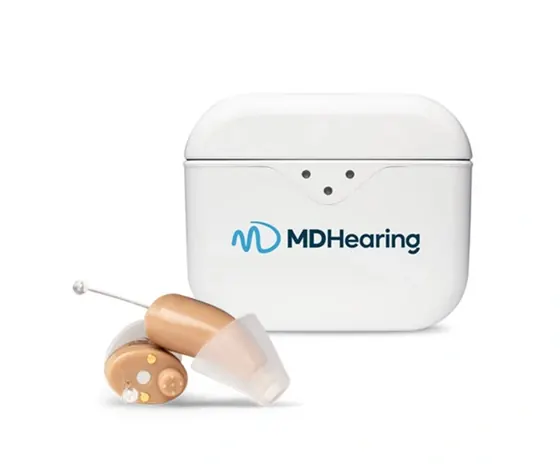 MDHearing NEO XS in-the-ear hearing aids beside their round charging case