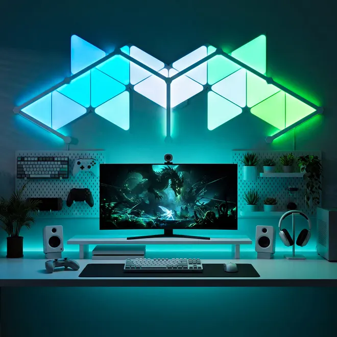The same panels arranged as a wide chevron in cyan and green above a desk with plants.