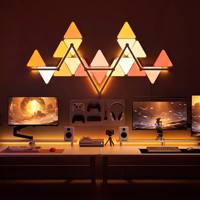 The same panels arranged as a row of warm orange peaks above a double desk.