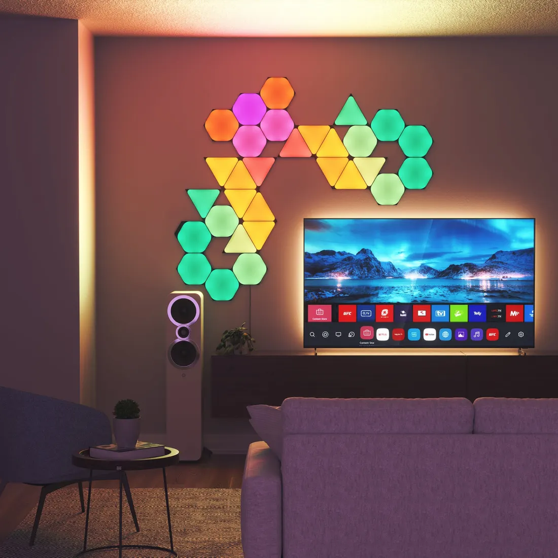 A living room wall with hexagon and triangle light panels mixed in one continuous design beside a television.