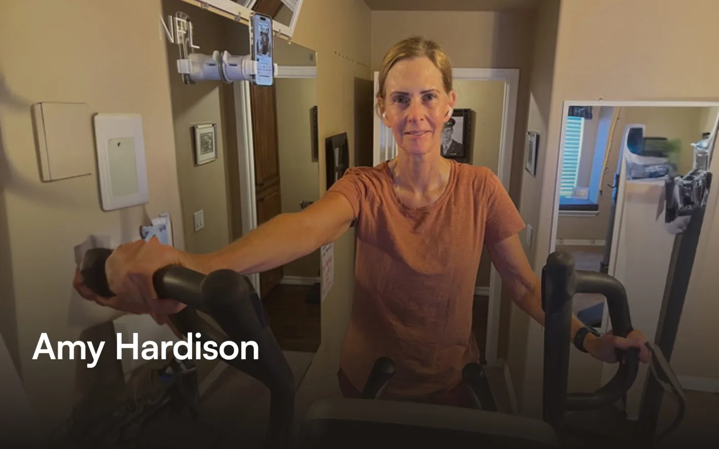 Amy Hardison, 64, exercising on an elliptical machine at home