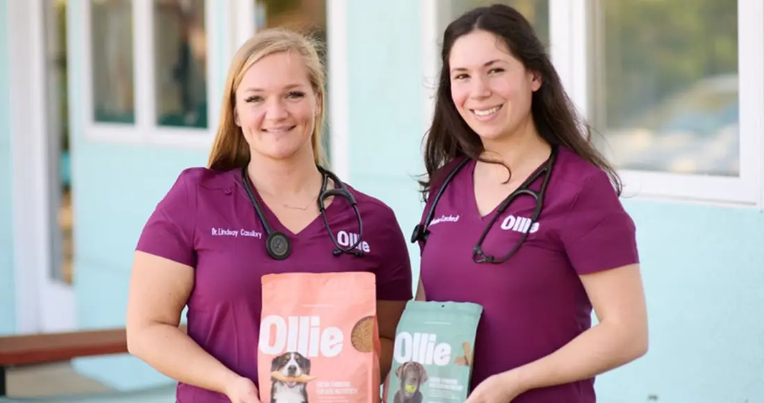 Two veterinarians holding Ollie packaging