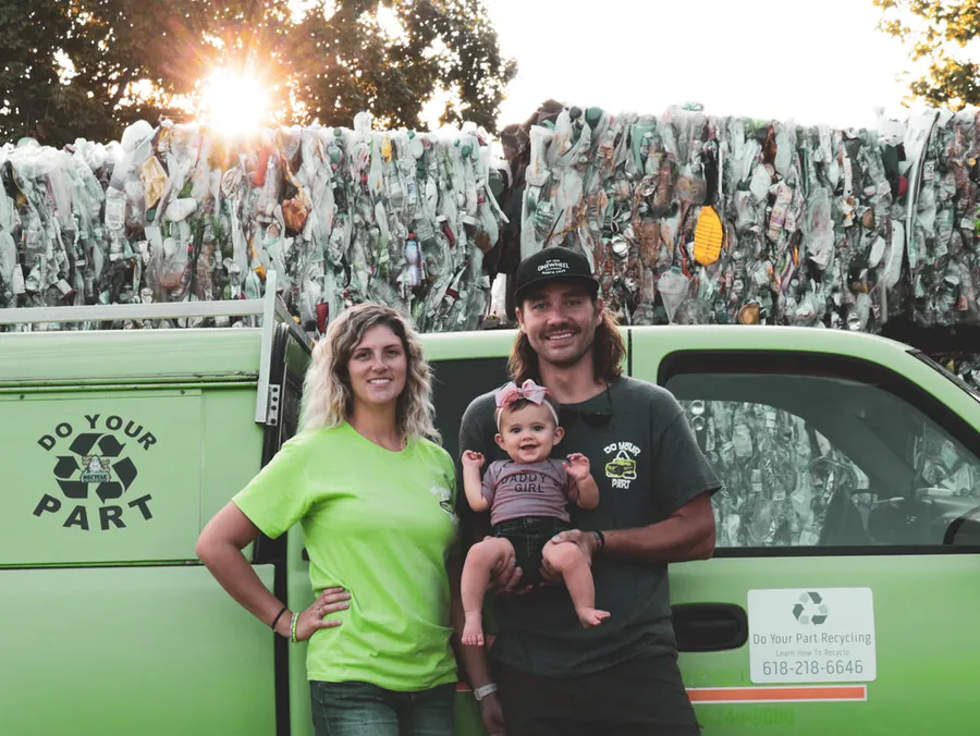 Andy Lamont with his family beside a green pickup truck marked Do Your Part Recycling.
