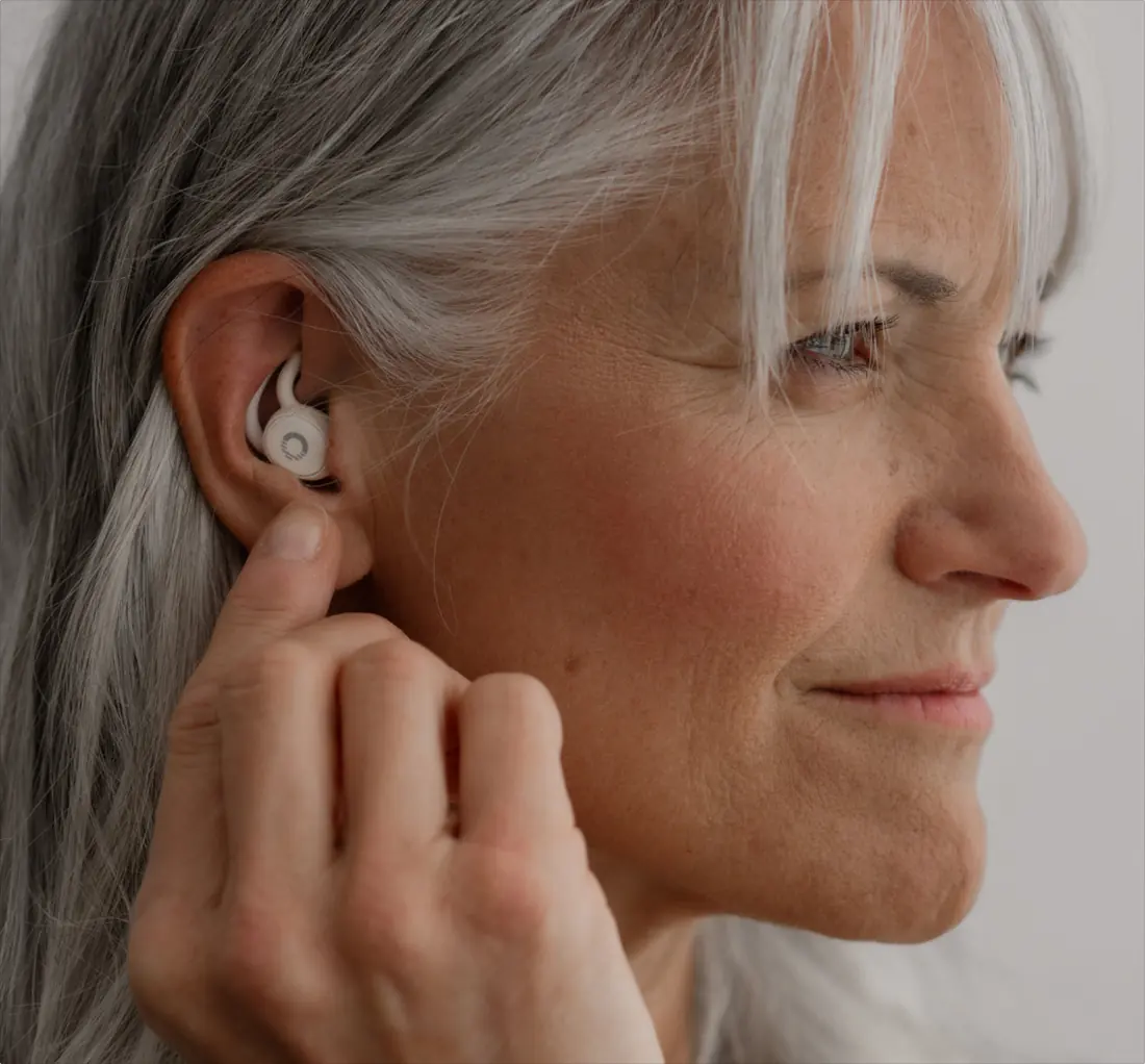 Close-up of a sleep earbud sitting flush inside the ear, barely protruding