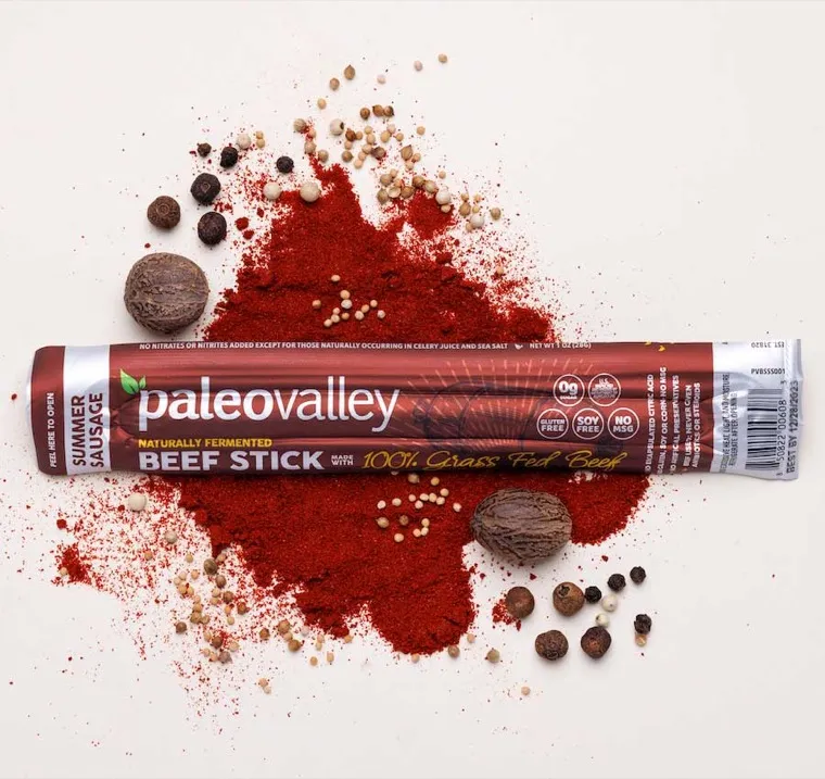 A beef stick surrounded by organic spices