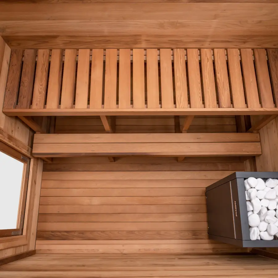 Overhead view of the finished interior of a Cove sauna showing the bench, backrest and stone heater