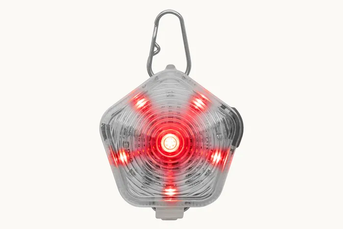 The Beacon safety light glowing red through its translucent shell