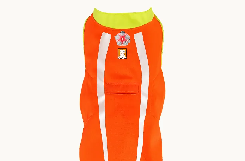 Top view of the Lumenglow vest with a star-shaped Beacon safety light clipped to the loop on the back